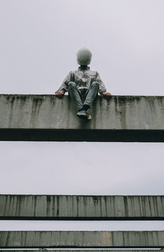 Abstract scene with person with white helmet/mask and silver jacket .