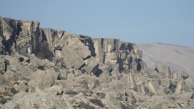 Gobustan is the national reserve of Azerbaijan. Petroglyphs of the ancient inhabitants of the planet. Ancient rock carvings, wild mountain landscapes, mountains and tourists.