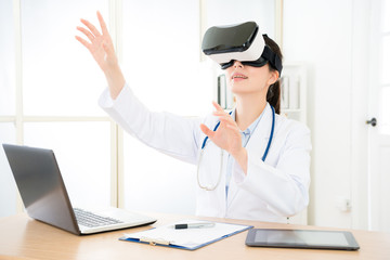 Fototapeta premium attractive pretty doctor wearing VR technology
