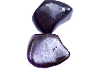 Deep purple Manganese with sugilite tumbled stone from South Africa isolated on white background