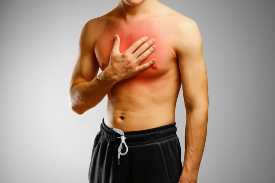 The guy with no shirt holding hand of patient's chest. The pain in his chest. The location of the pain marked in red
