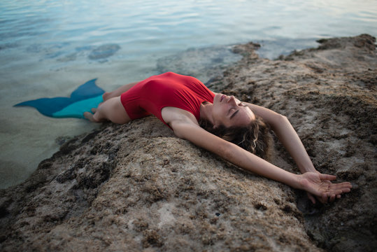 Young Female Lying With Mermaid Swim Fin