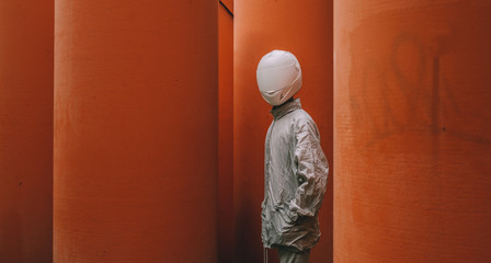 Abstract scene with person with white helmet/mask and silver jacket i.