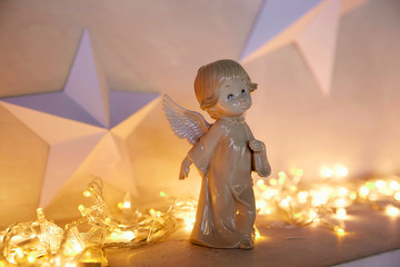 statue of an angel on the background of a New Year's garland