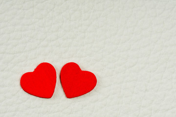 valentine's day card, two red hearts on white leather