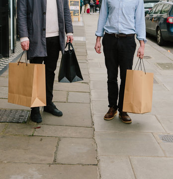 Two male friends shopping in London.