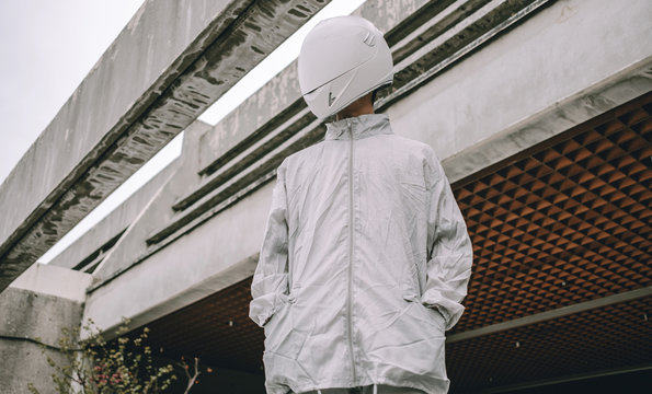 Abstract scene with person with white helmet/mask and silver jacket