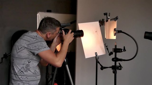 a young photographer in the process of working in a photography studio. unintended photography