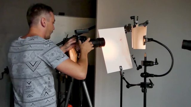 a young photographer in the process of working in a photography studio. unintended photography