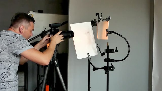 a young photographer in the process of working in a photography studio. unintended photography