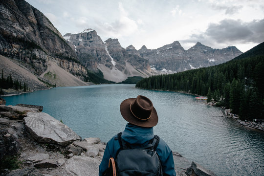 Man enjoying the view around the lake under the mountains in Canada.