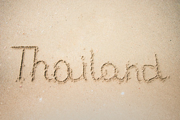 Thailand word is written on the beach sand