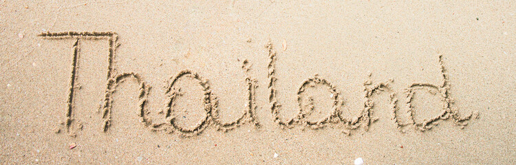 Thailand word is written on the beach sand