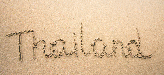 Thailand word is written on the beach sand