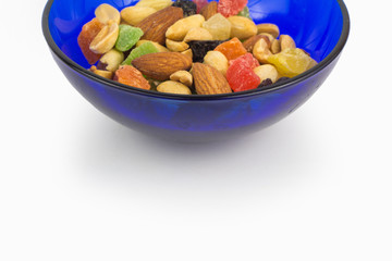Dried fruits and nuts in blue bowl, concept of proper nutrition