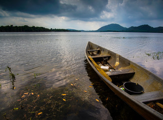 Fototapeta premium Boat Moored On Lake Against Sky During Sunset