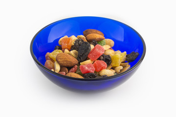 Dried fruits and nuts in blue bowl, proper nutrition