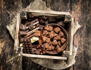 Different chocolate and sweets in an old box.