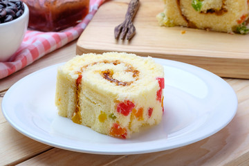 Sliced Cake Roll on wooden background