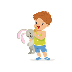 Adorable preschool boy holding bunny toy and eating tasty ice-cream on stick. Cartoon child character in green t-shirt and blue shorts. Flat vector design