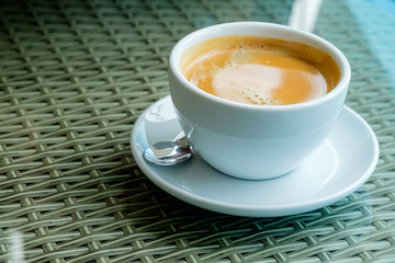 Hot coffee in a glass of coffee on a glass table.