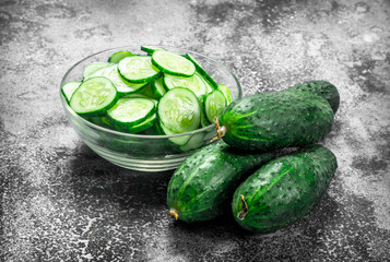 Slices of fresh cucumbers in a bowl.