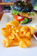 Black burger with pork and crispy onion