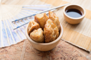 Fried dumplings on wooden bowl