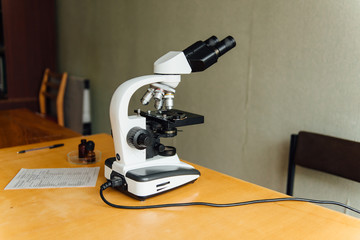 Scientist using a microscope in a laboratory