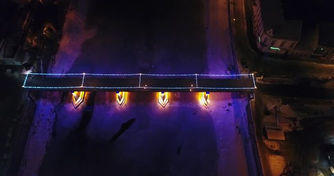 Aerial view: Fire Theater near the illuminated bridge on frozen river