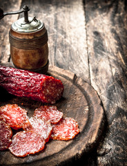 salami with herbs and spices on a board.