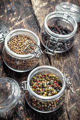 Various spices in glass jars.