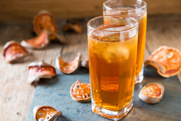 Bael juice ice tea on wooden table , healthy drink