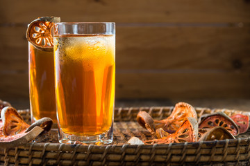 Bael juice ice tea on wooden table , healthy drink
