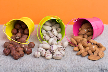 Almonds, hazelnuts, pistachios in small buckets