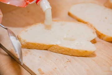Bread with sauce. A bread slice with mayonnaise, with sauce.