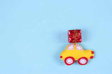 holiday concept with gift boxes on toy cars on blue background