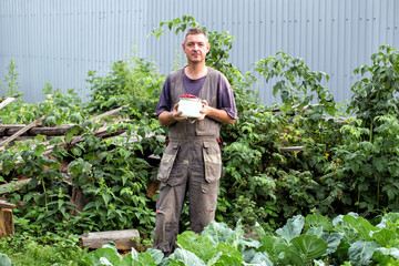 Man with a can of red cherries