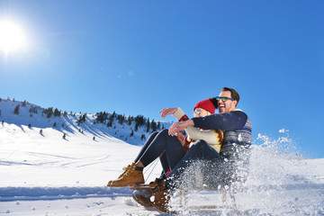 Fototapeta na wymiar romantic winter scene, happy young couple having fun on fresh show on winter vacatio, mountain nature landscape