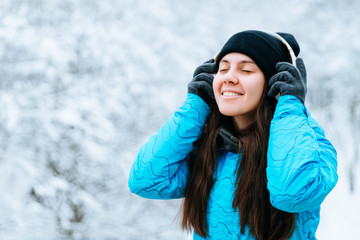 Fototapeta na wymiar young woman walk in snowy day with headset