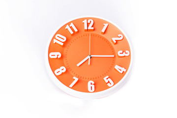 beautiful Orange clock on white background ,concept of Start the morning to work.