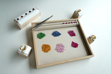 working path gem in wooden and leather plate with tool beside on white table