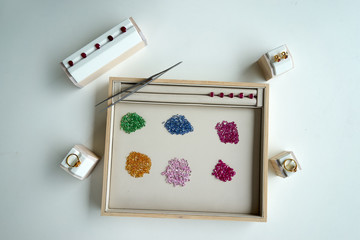 working path gem in wooden and leather plate with tool beside on white table