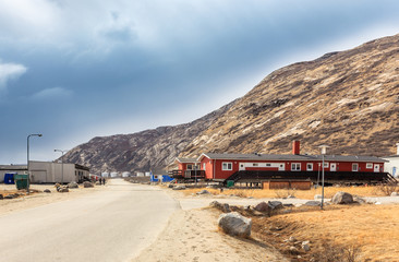 Street in Kangerlussuaq settlement with small living houses among mountains, Greenland © vadim.nefedov