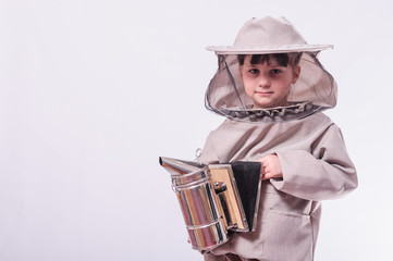 A little girl wears an over sized bee suit in studio white background.