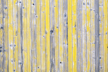 Wooden background with gray and yellow peeled paint