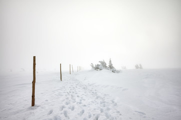 Hiking shoes imprints in snow, blizzard in Karkonosze mountains, winter landscape, Poland.