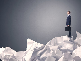 Businessman standing on crumpled paper