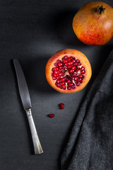 Sliced pomegranate with juicy red grains