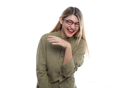 Studio shot of cute positive young European female in good mood laughing out loud at funny joke, leaning forward and closing eyes with pleasure. Human emotions, laughter, joy and fun concept